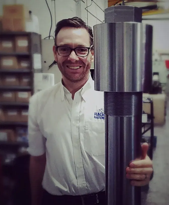 HAGUE FASTENERS engineer holding a large nuclear stud bolt