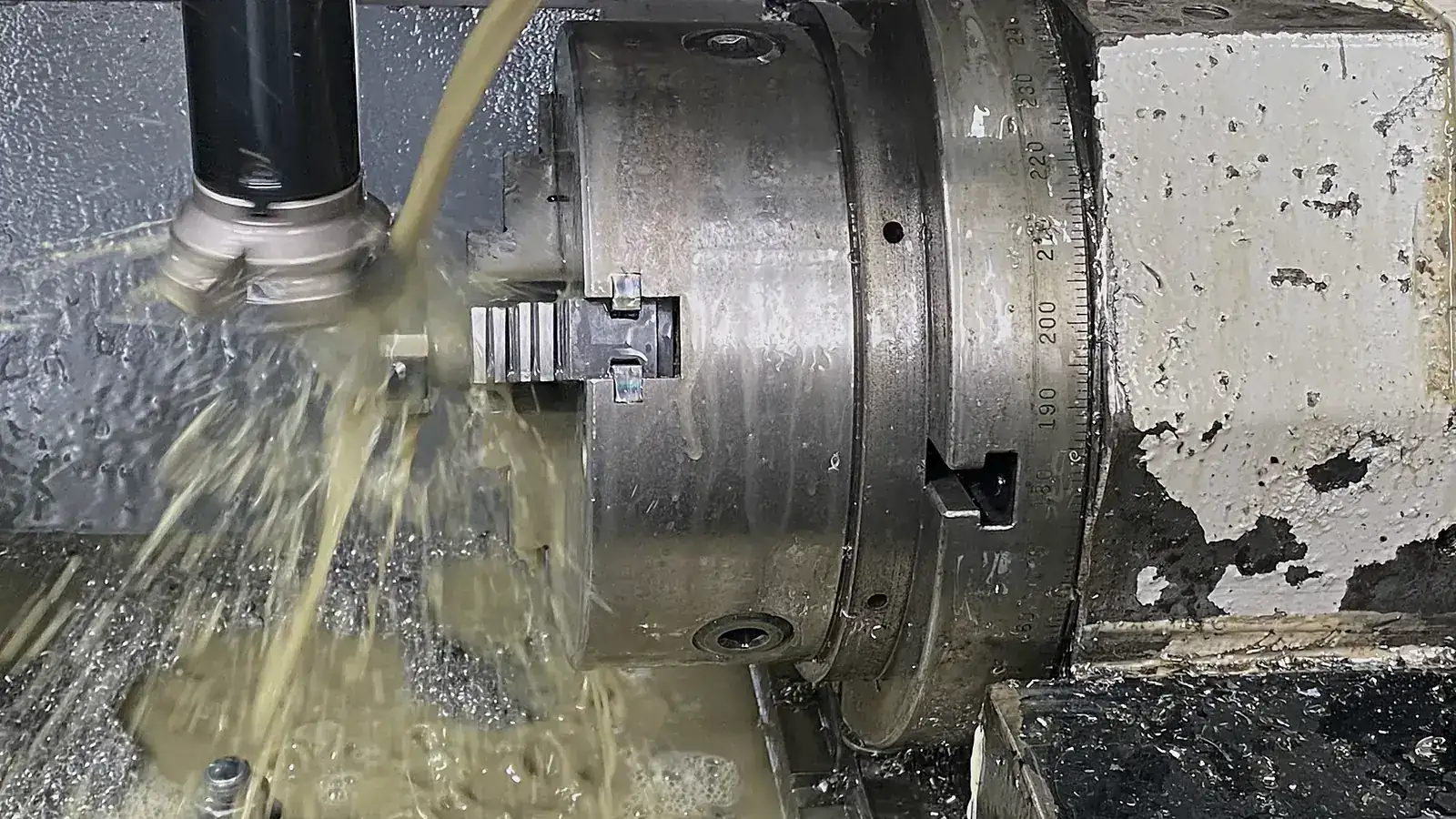 Milling a part held in a rotary chuck, with coolant flowing, at HAGUE FASTENERS