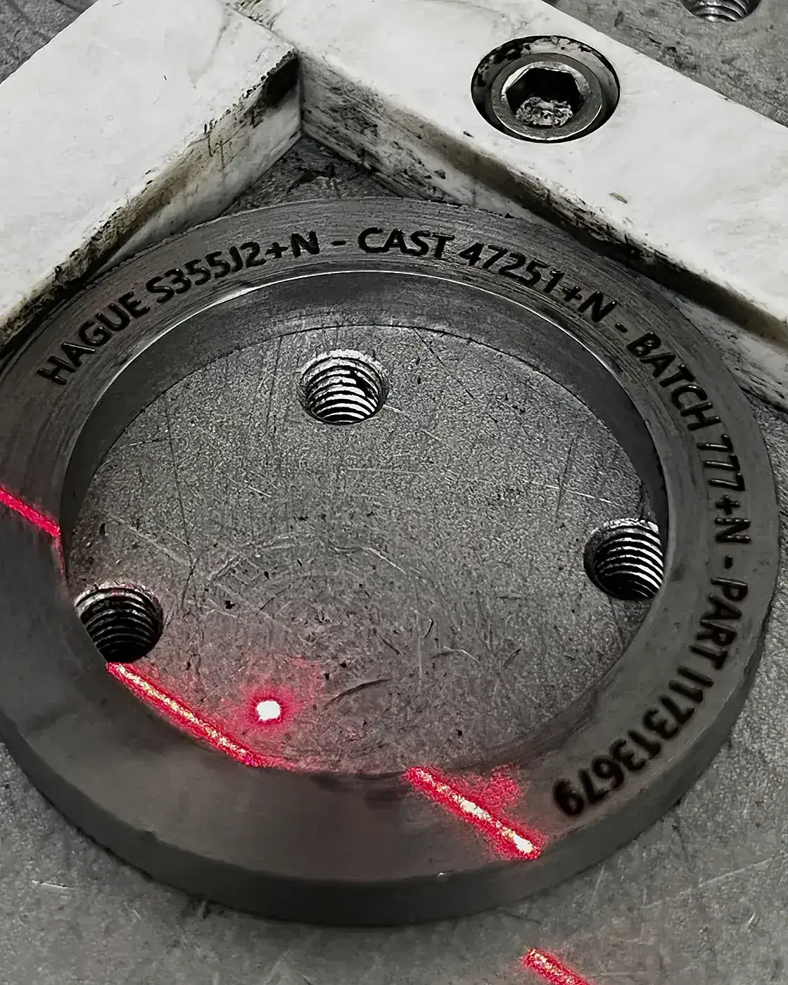 Laser marking a part with its grade and batch identity